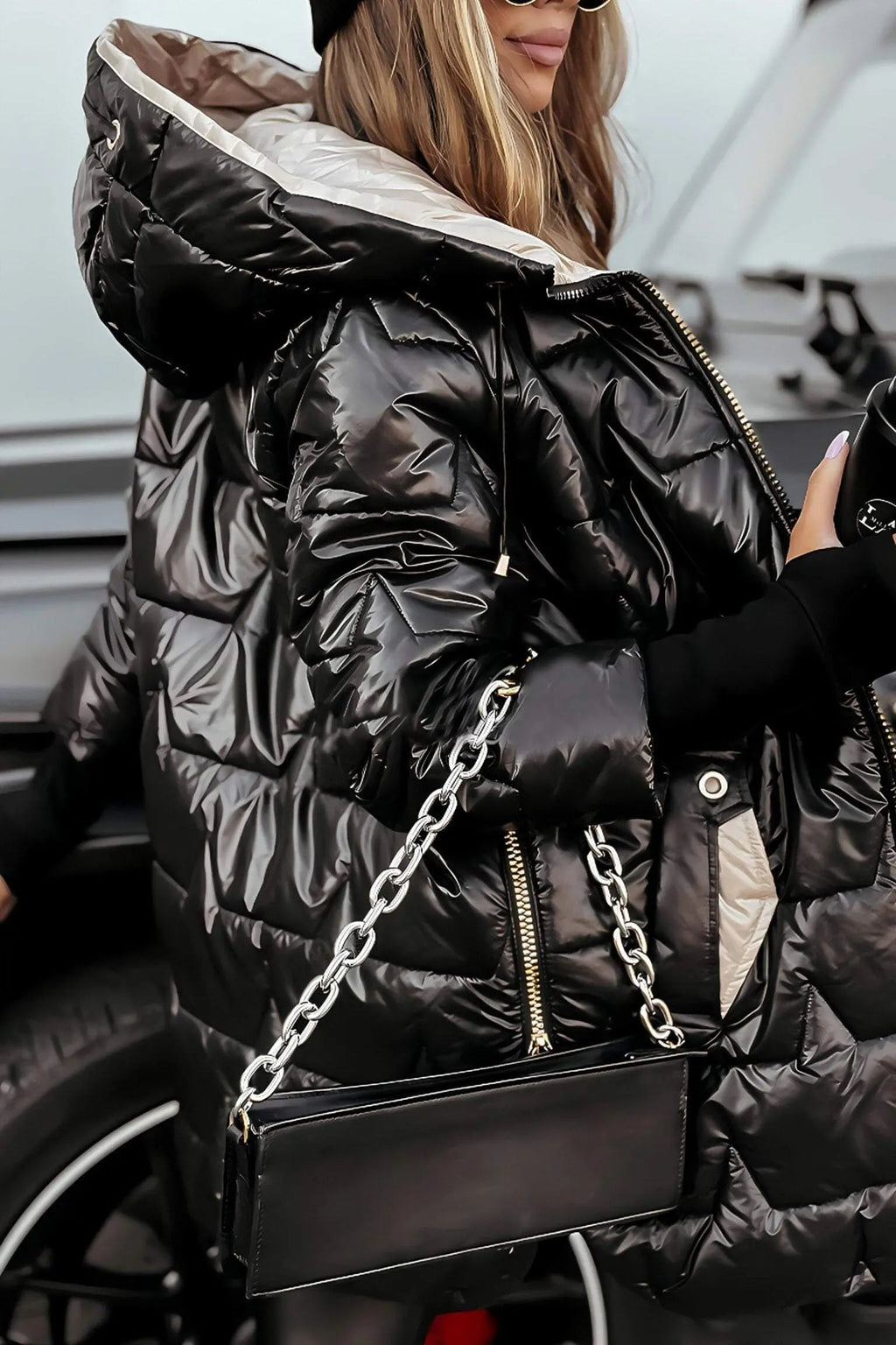 Black hooded puffer jacket with full zipper and quilted diamond stitch pattern
