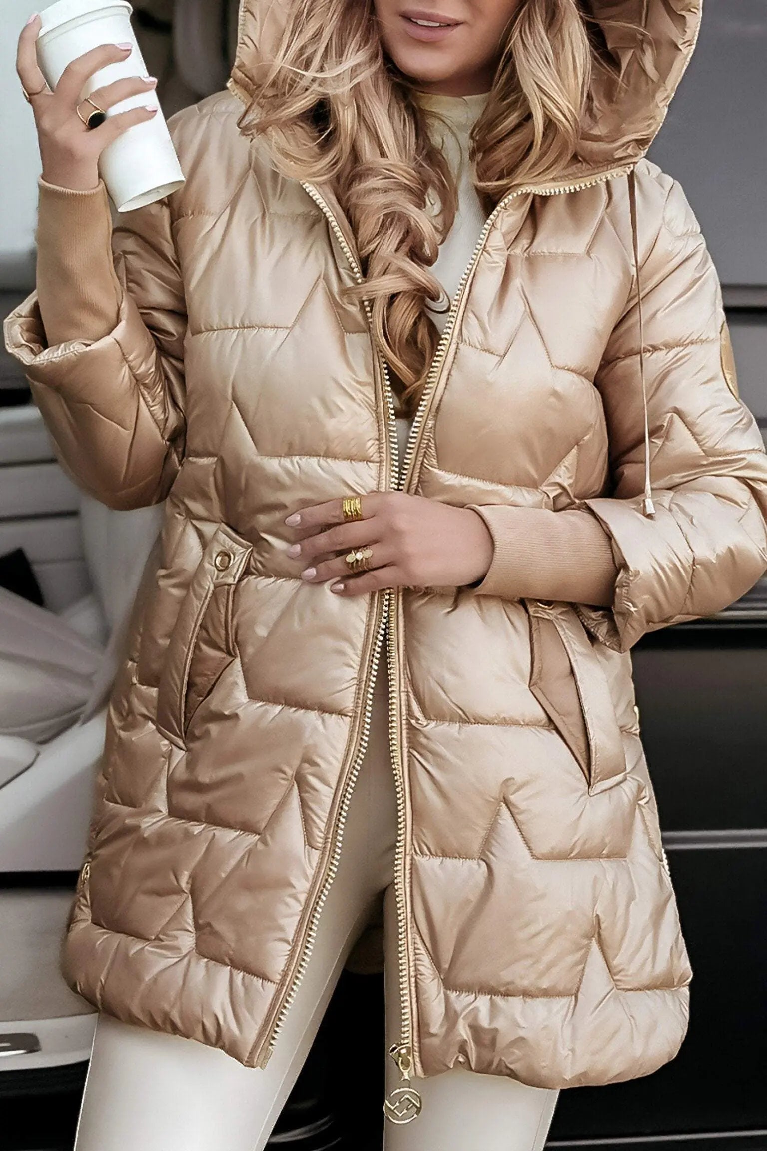 Light beige hooded puffer jacket with full zipper, front pockets, and drawstring hood