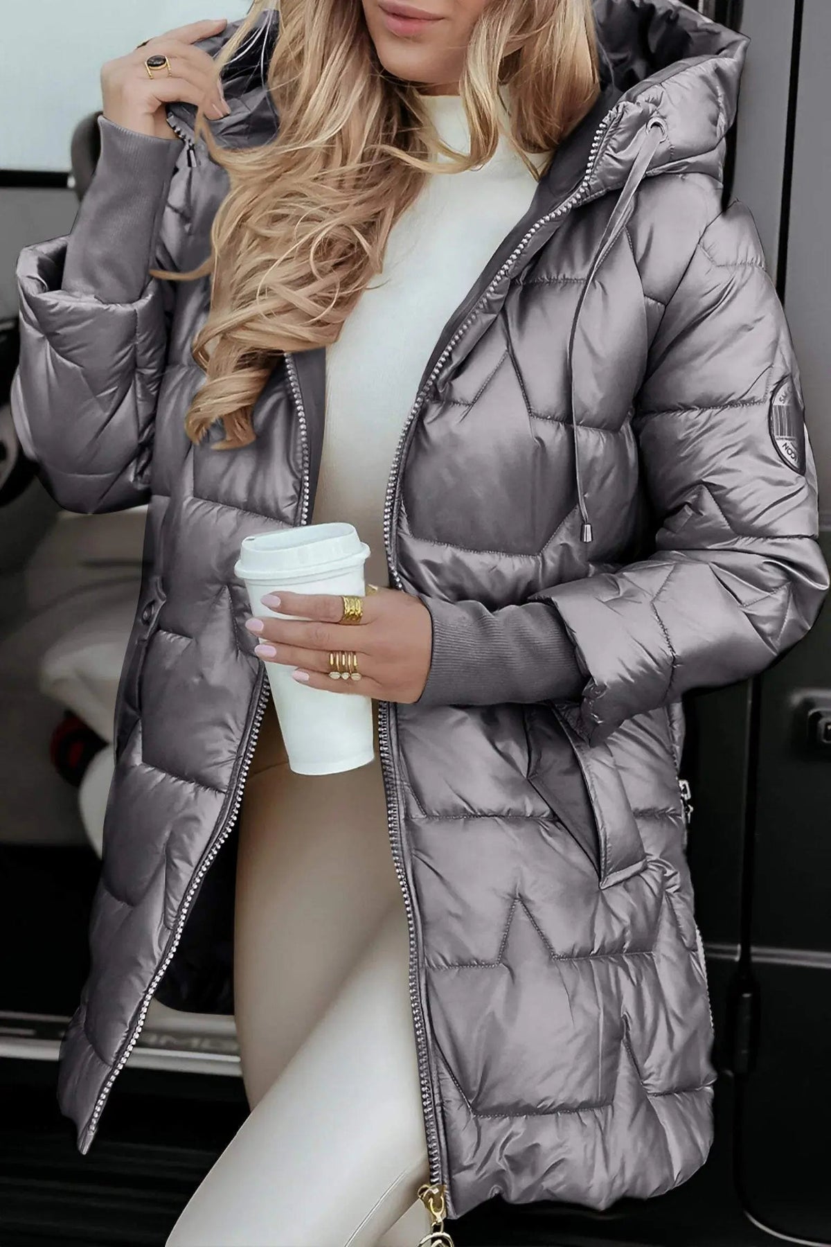 Grayish taupe hooded puffer jacket with full zipper, front pockets, and drawstring hood