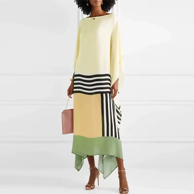 Statement caftan dress in pale yellow with black-and-white stripes and green hem drape