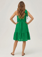 Green one-shoulder knee-length dress, back view with bow strap and tiered skirt