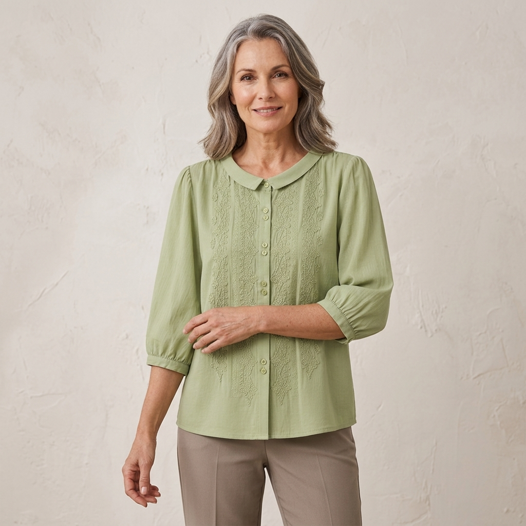 Embroidered Peter Pan collar blouse on model, light green button front with 3/4 sleeves